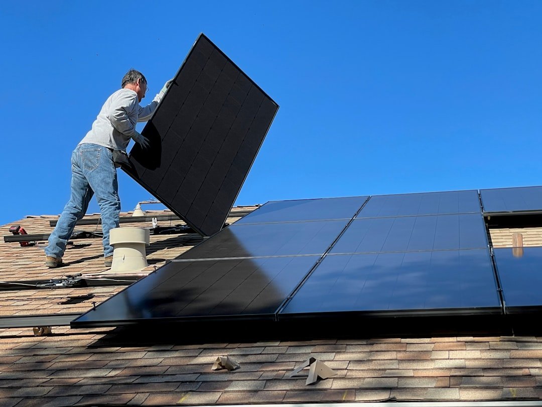 The Future of Residential Solar Power and Sustainable Living Worker installing solar panels on a roof
